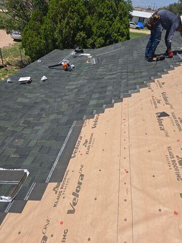 Crew members installing the shinlges.