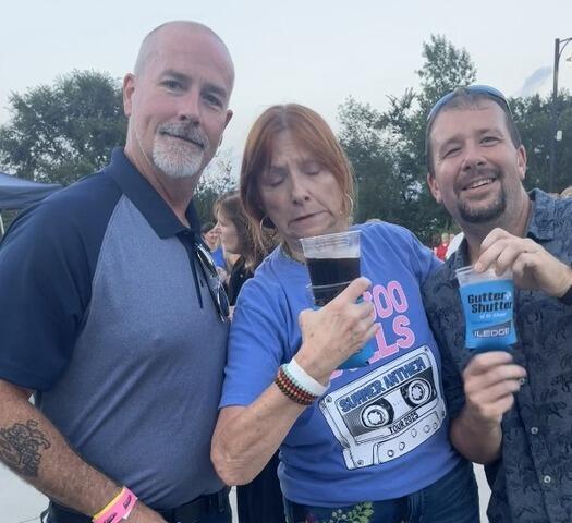 Jamie with a Couple having fun enjoying some Gutter Shutter Swag!