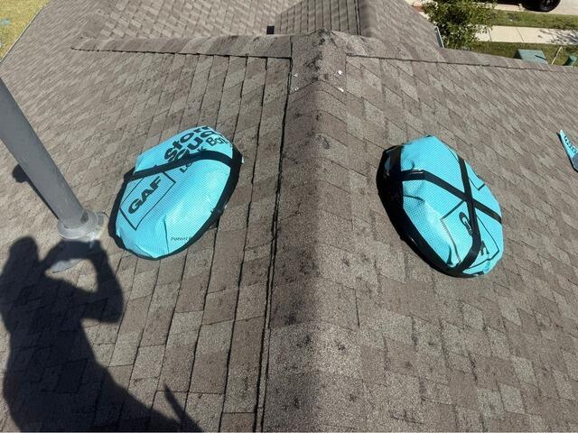 Hail-Damaged Roof and Vents Covered with Temporary Patches in Anna