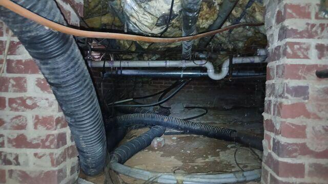 Before Waterproofing - Signs of Moisture and Clutter in Crawl Space (Gibsonville, NC)