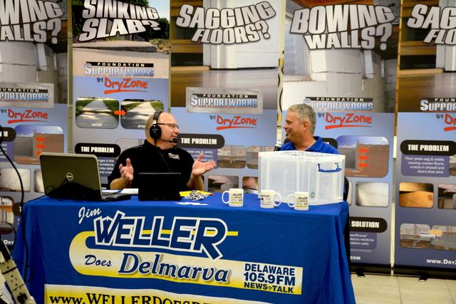 Barry Adkins, system design specialist, talking with Jim Weller about a few special projects that he had worked on lately. 
A homeowner told him, "You saved my home."