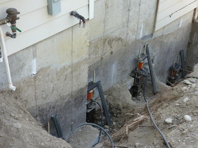 Four of the thirteen piers that have been installed and equipped with the components required to perform a uniform lift.