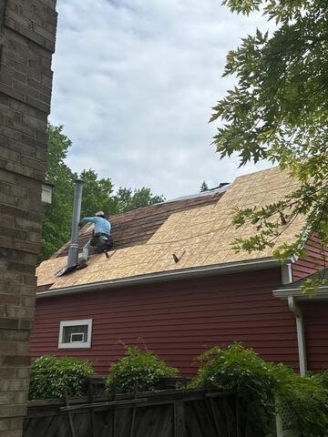 Old shingles being removed and replacing the damaged decking