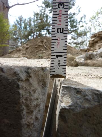 This photo was taken after the lift process was complete. This photo illustrates the shear movement at the top of the walls between the active foundation and the abandoned foundation. The cut seen in the photo was made to separate and free the active foundation to move. This section of the home was only required to be lifted 0.5", the importance was to permanently stabilize this area. This photo indicates 0.5" of shear movement between the stationary wall and the active wall.