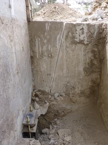 This photo illustrates the angled relief cut that was made to relieve the load off the active foundation and was taken after the foundation was lifted. You can see evidence of the movement in two instances. The top of the wall was once flush and continuous, the section attached to the active foundation is now 0.5" higher. Additionally, there is greater separation between the two wall sections at the saw cut line.