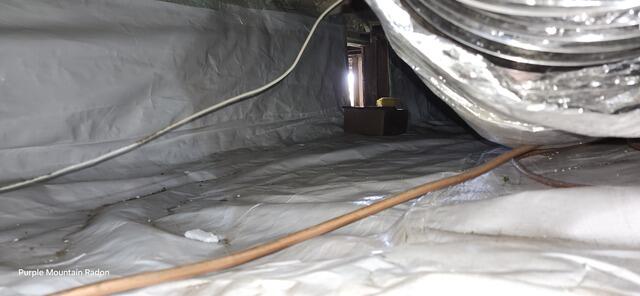 One of four crawlspaces beneath the structure