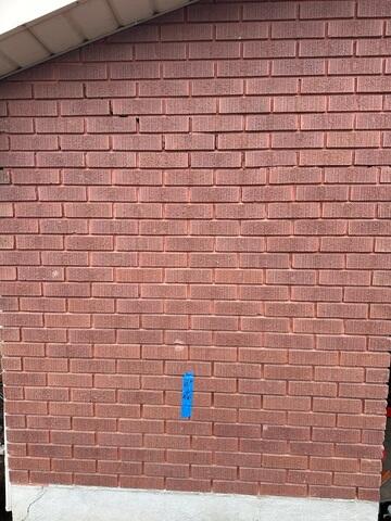 Marked Foundation Repair Locations on Exterior Wall