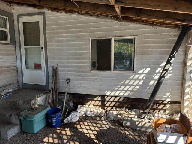 Before Photo of Crumbling Foundation Held Up With Sand Bags