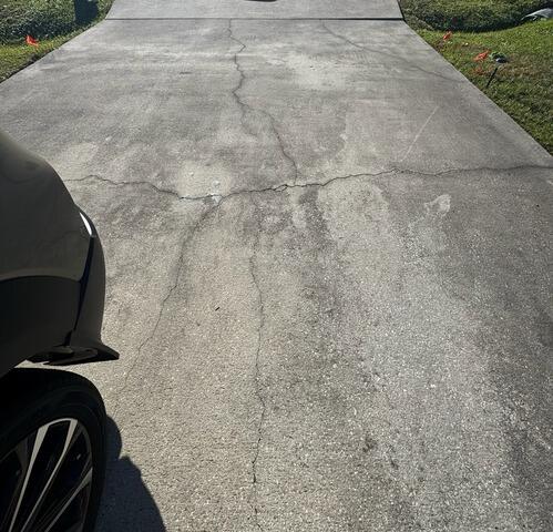 Cracked and Settling Concrete Driveway