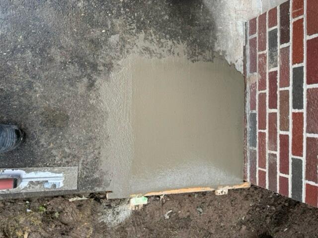 To finish the job, we hid the piers with a layer of concrete, blending right into the driveway so they're not immediately visible.