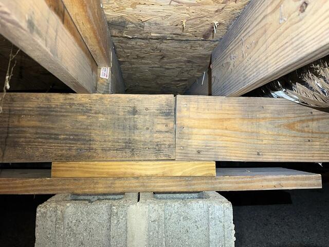 Upon inspection, we found a weakening main beam, or girder, that needed better support. You can also see where moisture may have started to impact the wood.