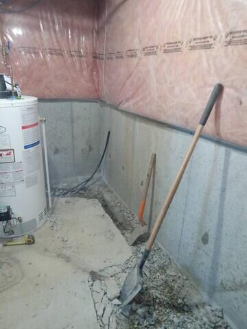 A trench is opened up around the perimeter to installed the drain tile.