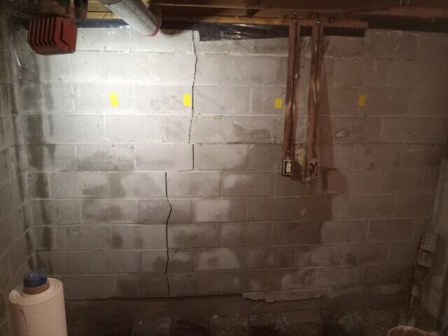 This is sure sign that you have a bowing wall. The vertical cracking connects with the horizontal crack. This is caused by soil expansion or frost heave.