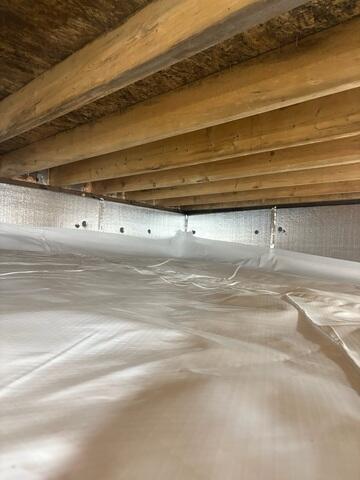 To fix the damp, moldy crawl space under the office, the Alford crew installed CleanSpace, a vapor barrier that reduces moisture, seals out cold drafts, and protects from future mold growth.
