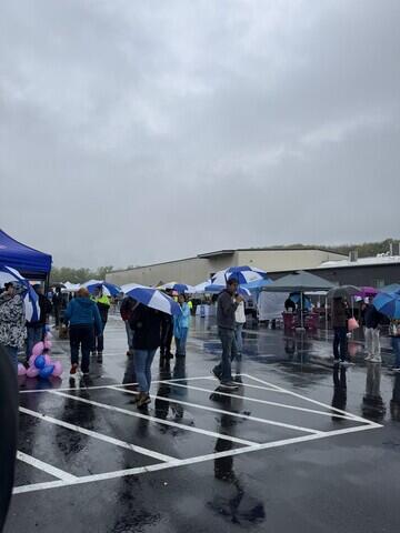 Attendees with Adirondack Basement Umbrellas