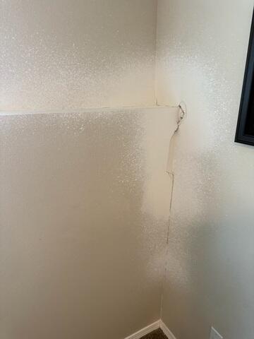 Cracking drywall over the bowing foundation wall