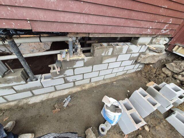 Temporary Jacks Supporting Home During Foundation Wall Rebuild