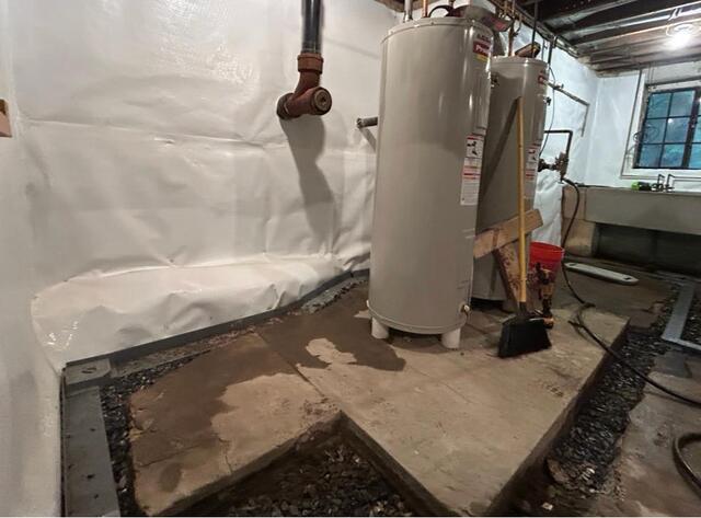 Prepping to lay WaterGuard and TrenchDrain