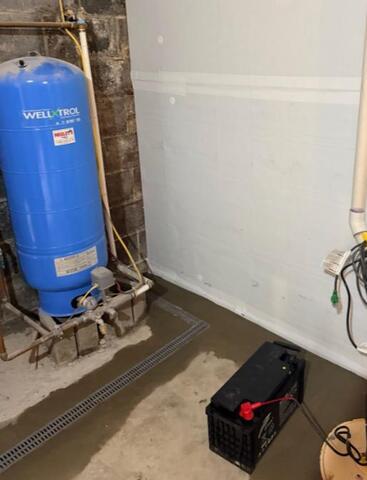 Trench drain around a water tank