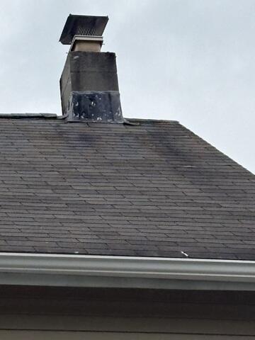 Aged Chimney and Worn Roof Surface