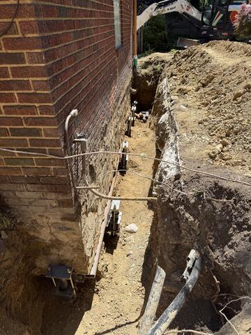 Helical Piers on The Side of The Homeowner's Garage