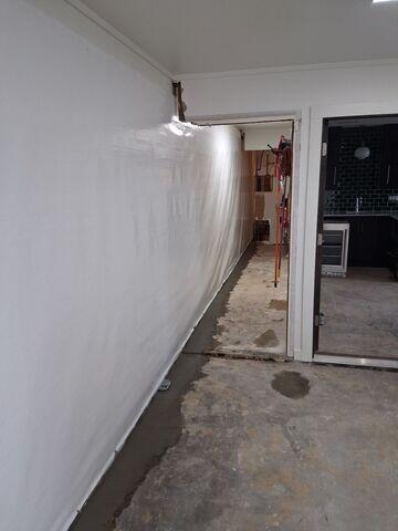 The CleanSpace Wall System with WaterGuard in the floor traps and drains water into the sump pump
