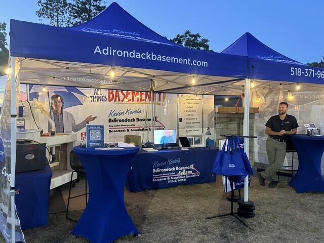Adirondack Basement Systems Booth At Night
