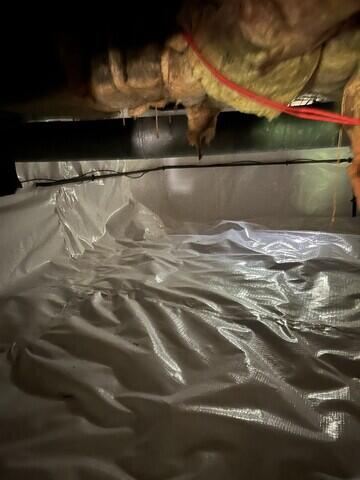 Vapor barrier sealed over floor and wall of crawl space
