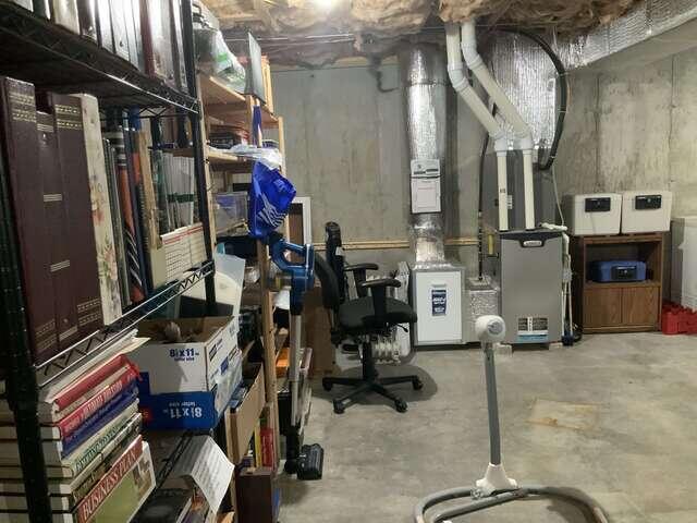 One-point radon piping installed in the unfinished basement.