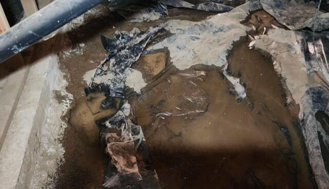 Torn, Wet Vapor Barrier