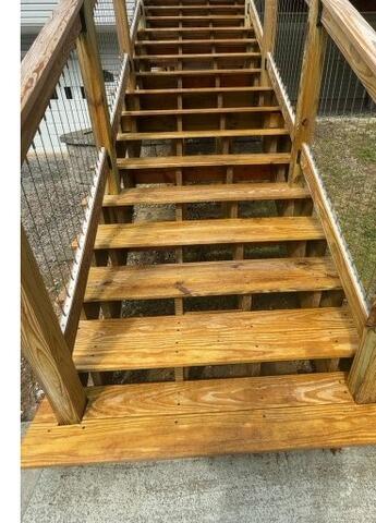 Fully restored and sealed wooden stairs highlighting rich natural wood grain and superior weather protection.