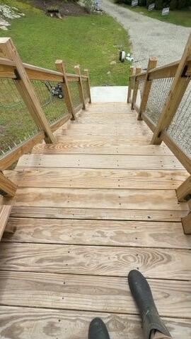Worn, faded deck treads before professional cleaning and protective wood treatment.