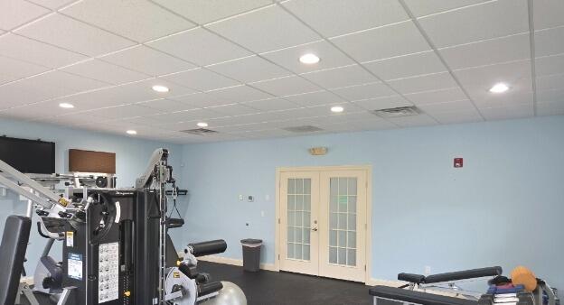 After: Freshly painted light blue walls instantly brighten the main workout zone.