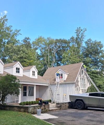 Work in progress: Freshly primed vertical siding ready for a smooth, high-durability finish coat