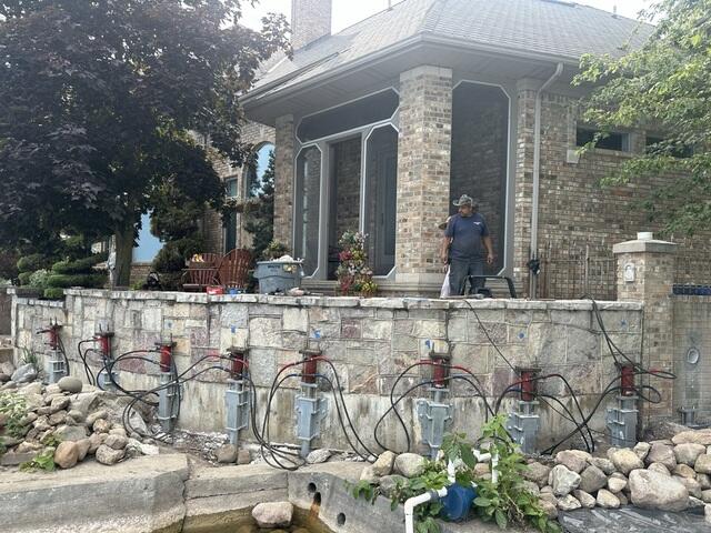 Push Piers Being Loaded to Stabilize the Retaining Wall