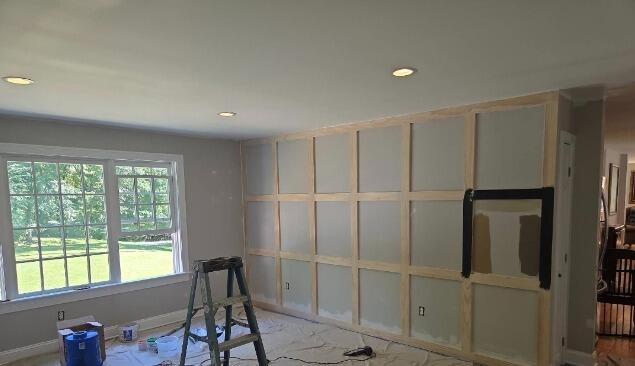 Framing out the custom grid accent wall and preparing the surface for paint at 9 Butterfield Rd, Newtown.
