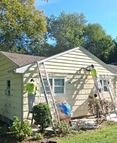 Detailed inspection and surface preparation along the side exterior to fix peeling paint and damaged trim.