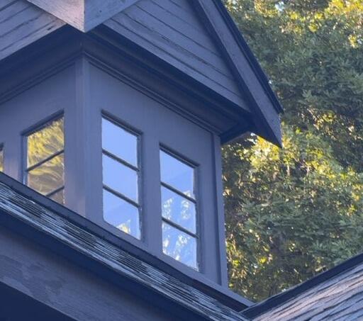 Precision exterior painting detail on a custom rooftop cupola and weather vane.