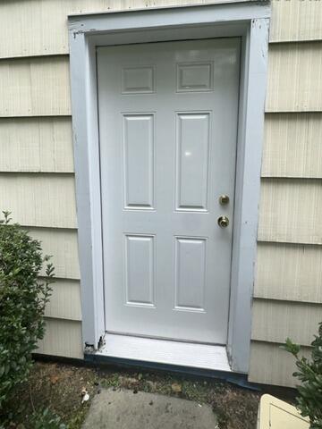 Detailed look at rotted door frame casing and base trim requiring structural repair.