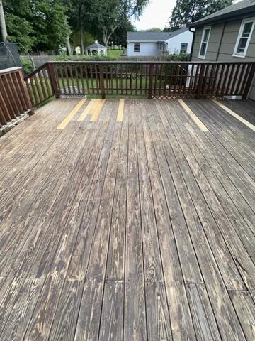 Fully repaired deck surface reinforced with structural board replacements, ready for staining