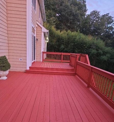 Freshly stained multi-level wood deck featuring a smooth, rich finish that guarantees long-lasting weather protection.