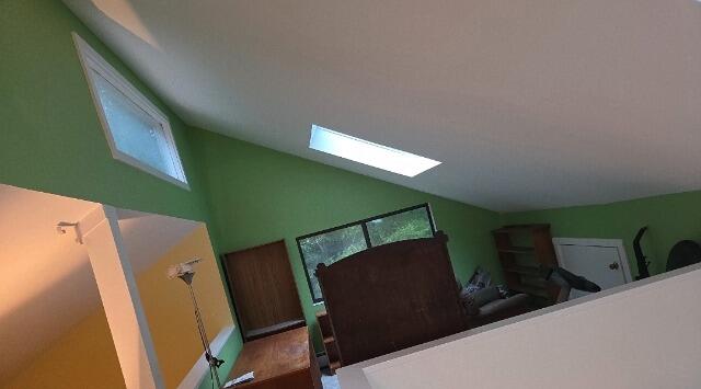 Fresh, vibrant custom interior painting completed on steep vaulted walls and skylight alcoves