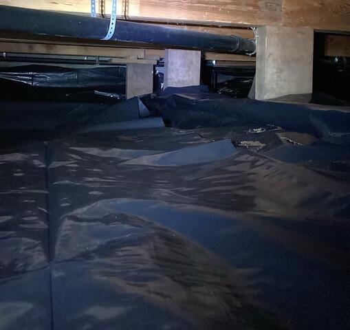 Vapor Barrier Placed Snuggly Around Subfloor Posts