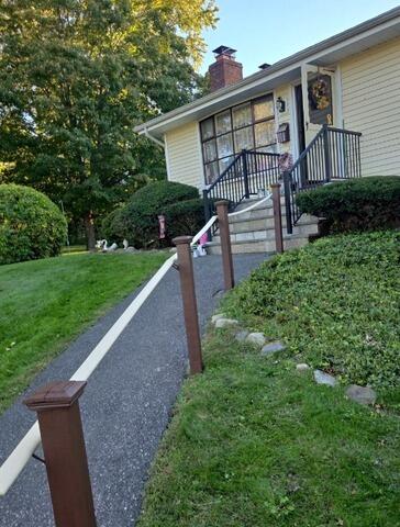 Complete exterior transformation featuring freshly painted porch railings, walkway posts, and front entryway.