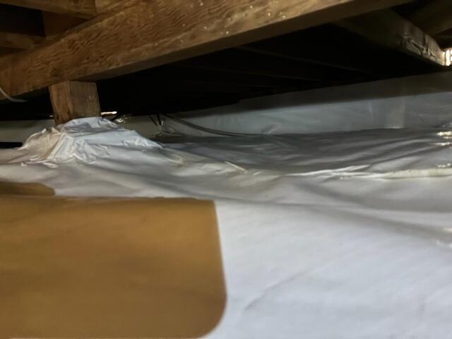 Vapor Barrier Fitted Around a Crawl Space Support Base