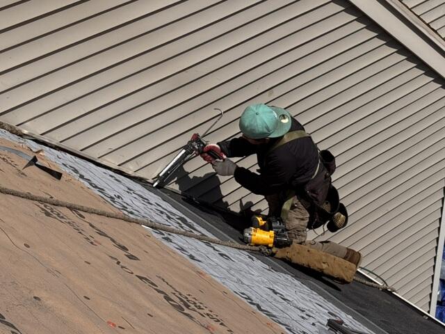 Installing Step Flashing Along the Roof-to-Wall Connection