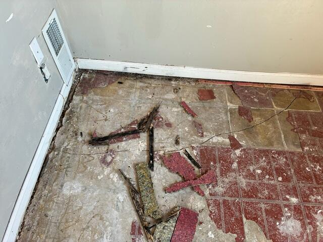 Concrete Floor Crack Near a Room Corner Before Repair
