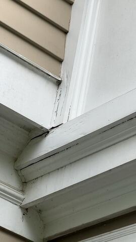 Before repair: Cracking seams, failed caulking, and water penetration risks along upper exterior trim