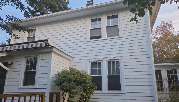 Complete exterior transformation with a durable, weather-resistant white paint finish protecting the entire back elevation.