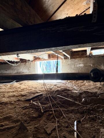 Exposed Soil and Debris Before Crawl Space Improvements